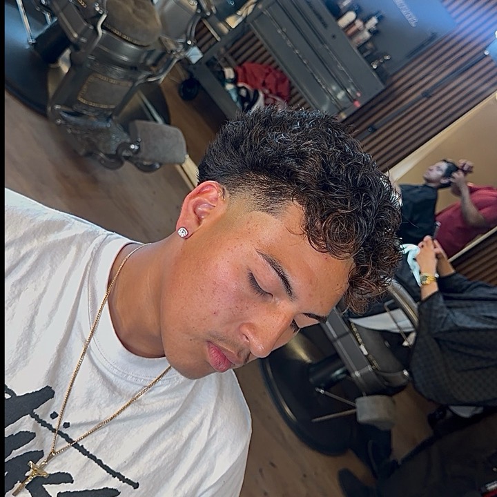 Curly top with a clean taper